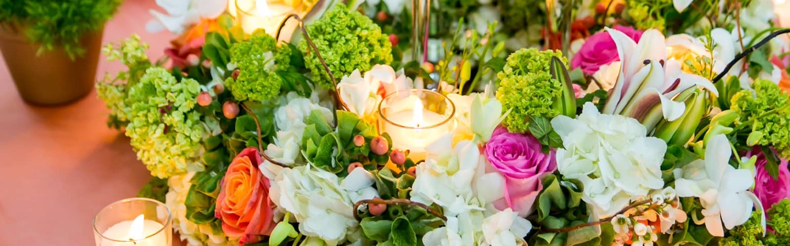 low colorful centerpiece, bright color centerpiece, viburnum, roses, hydrangeas, orchids, lilies, candles, chelsea mansion