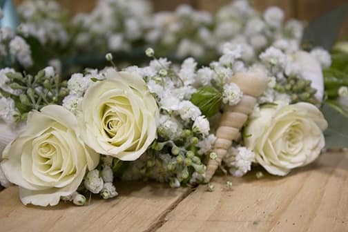 Close up of floral crown with spray roses baby's breathe and seashells, long island wedding flowers