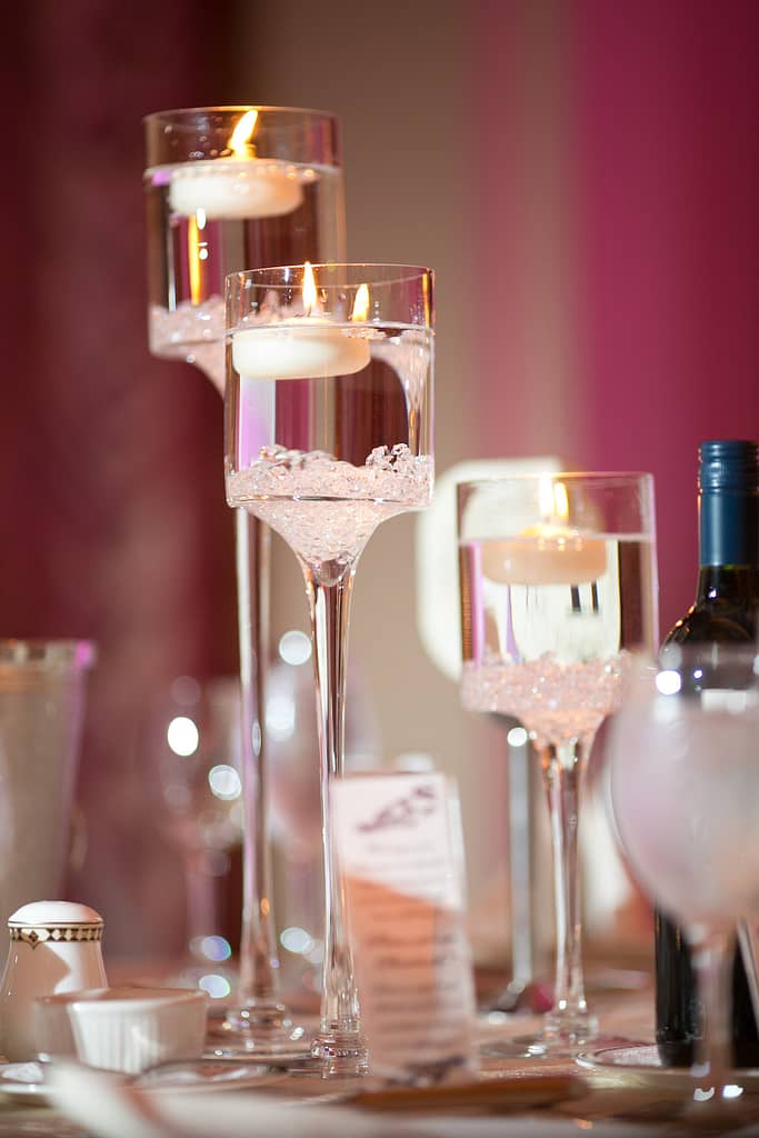 low centerpiece, large stemmed glass candle holders, candle holders, the larkfield, mini calla lilies, floating candles, small diamond gems