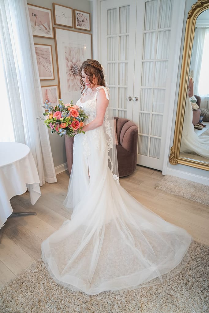 Sea Cliff Manor Wedding | Keirstin & James’ Colorful Fourth of July Celebration sea cliff manor wedding bride holding her bouquet in the bridal suite