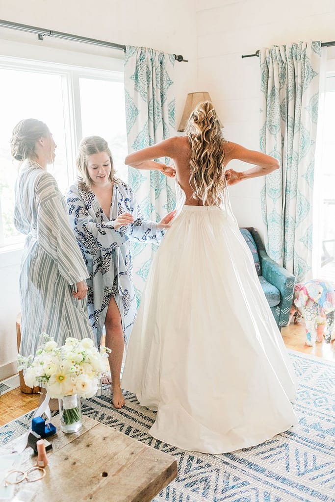 crows nest wedding cottages bridesmaid helping bride getting ready