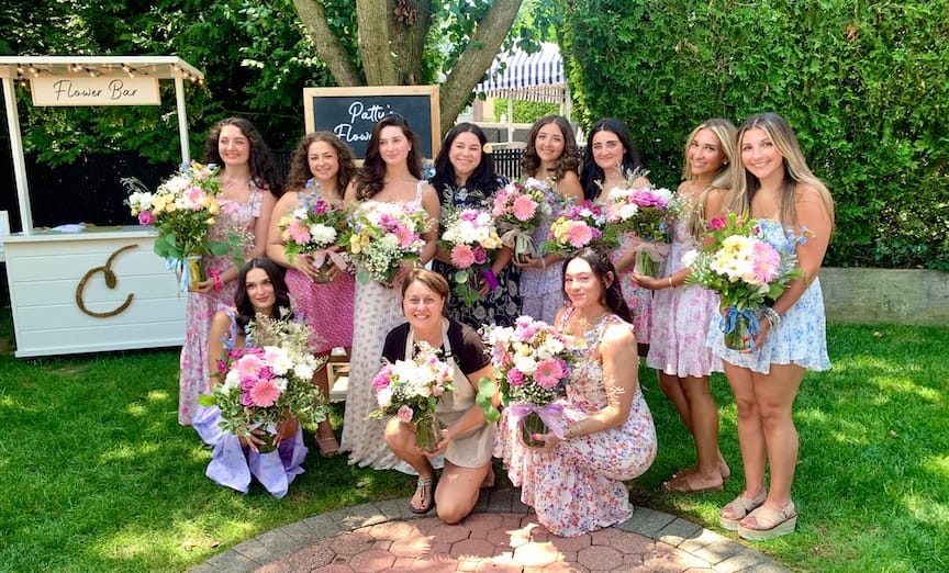 Floral Workshops | A Creative Experience to Share with Friends Ladies enjoying a flower workshop in Long Island, NY, proudly showing their handmade arrangements.
